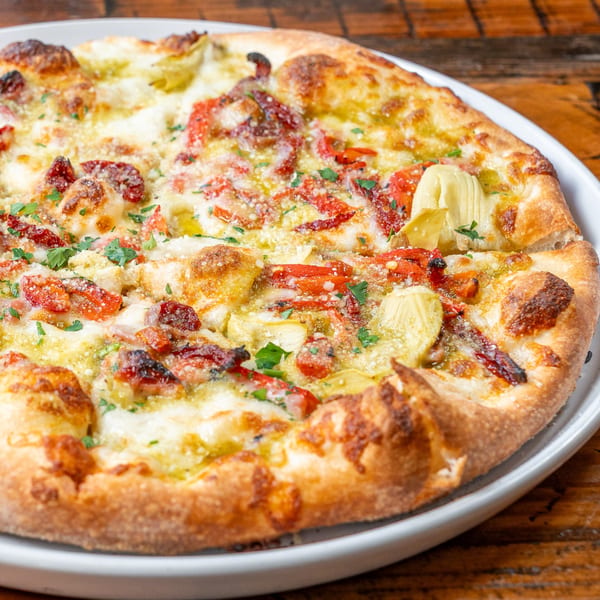 Cucina Pizza & Bar's Italian pizza with artichokes, sun-dried tomatoes, and fresh herbs.